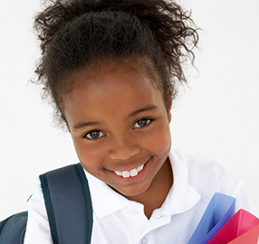 smiling girl with backpack and binders